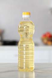 Bottle of cooking oil on white marble table in kitchen