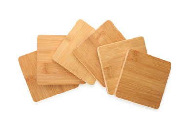 Wooden cup coasters on white background, top view