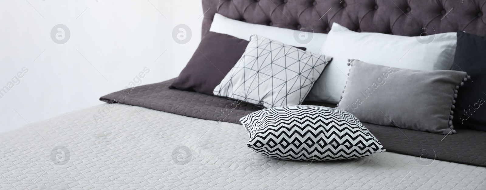 Image of Soft pillows on stylish bed in room. Banner design