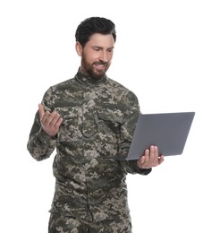 Photo of Soldier using video chat on laptop against white background. Military service