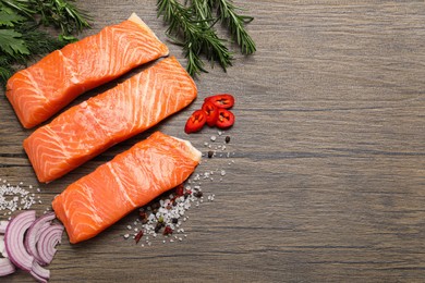 Photo of Fresh salmon and ingredients for marinade on wooden table, flat lay. Space for text