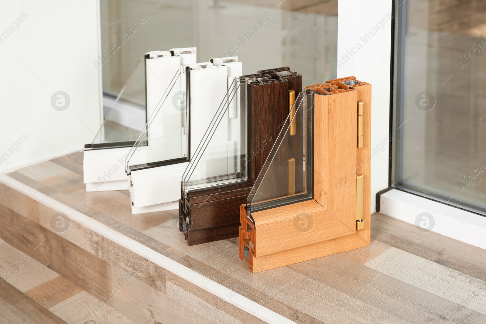 Photo of Samples of modern window profiles on sill indoors. Installation service