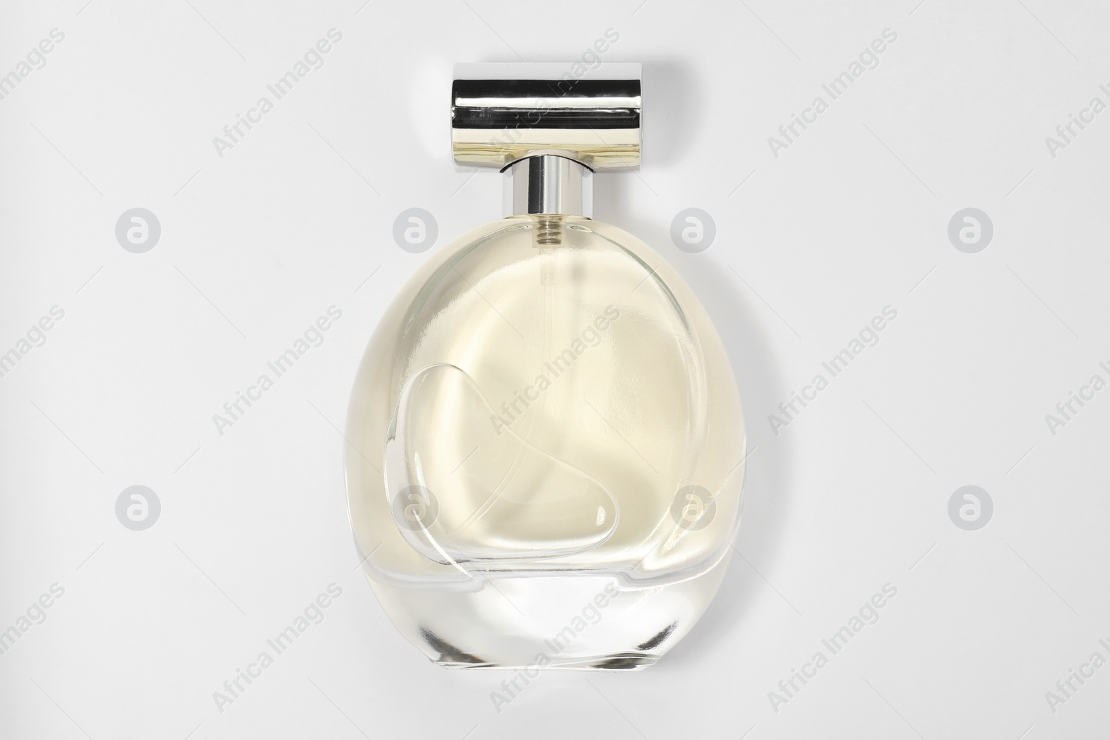 Photo of Luxury women's perfume in bottle on white background, top view