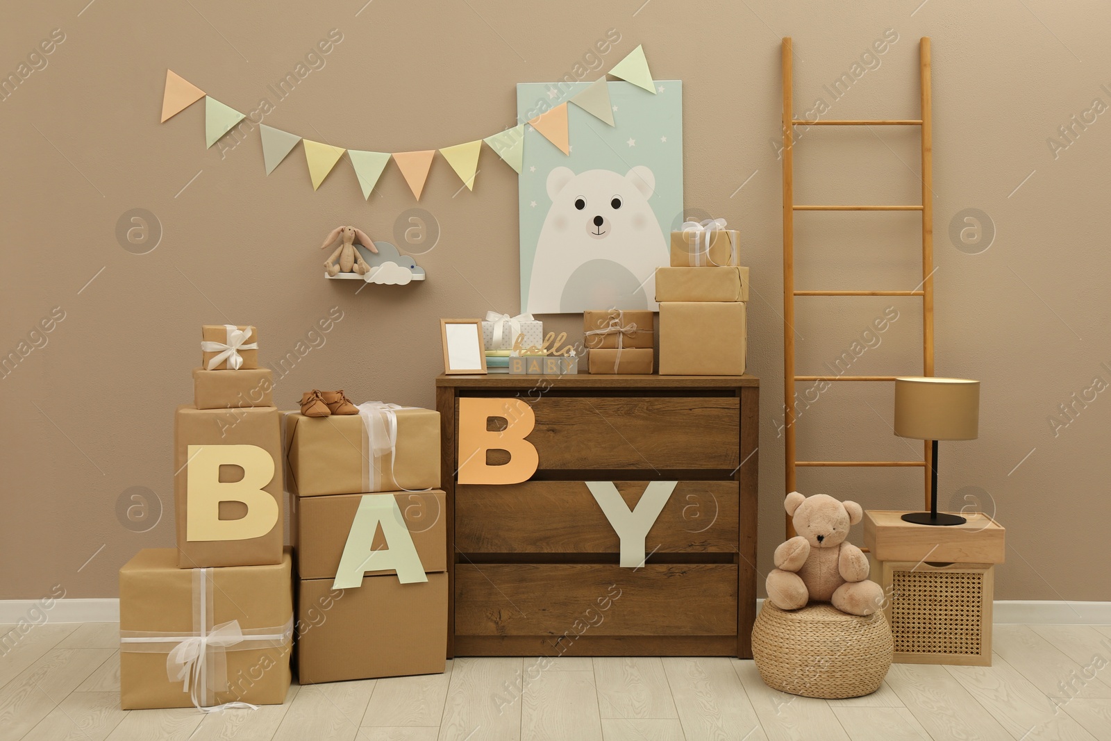 Photo of Gift boxes and toys in room decorated for baby shower party