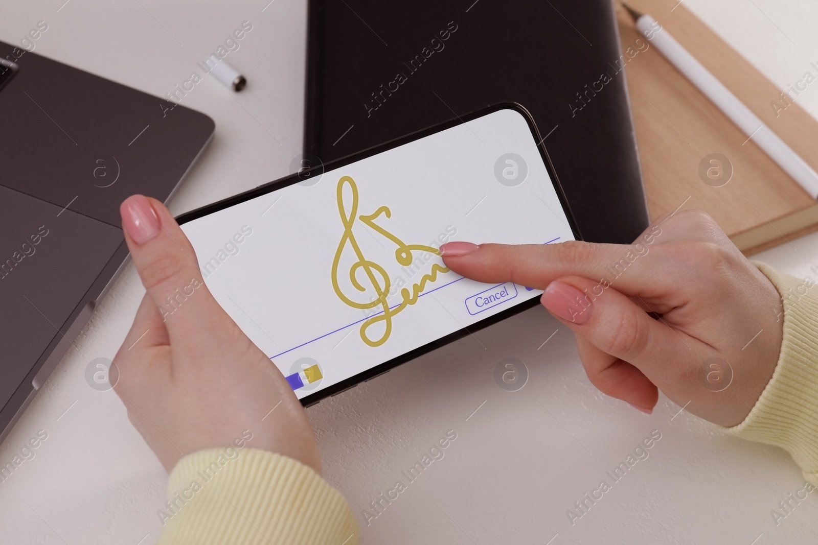 Image of Electronic signature. Woman using mobile phone at table, closeup