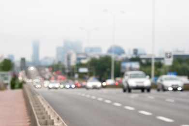 Photo of Blurred view of city road with cars