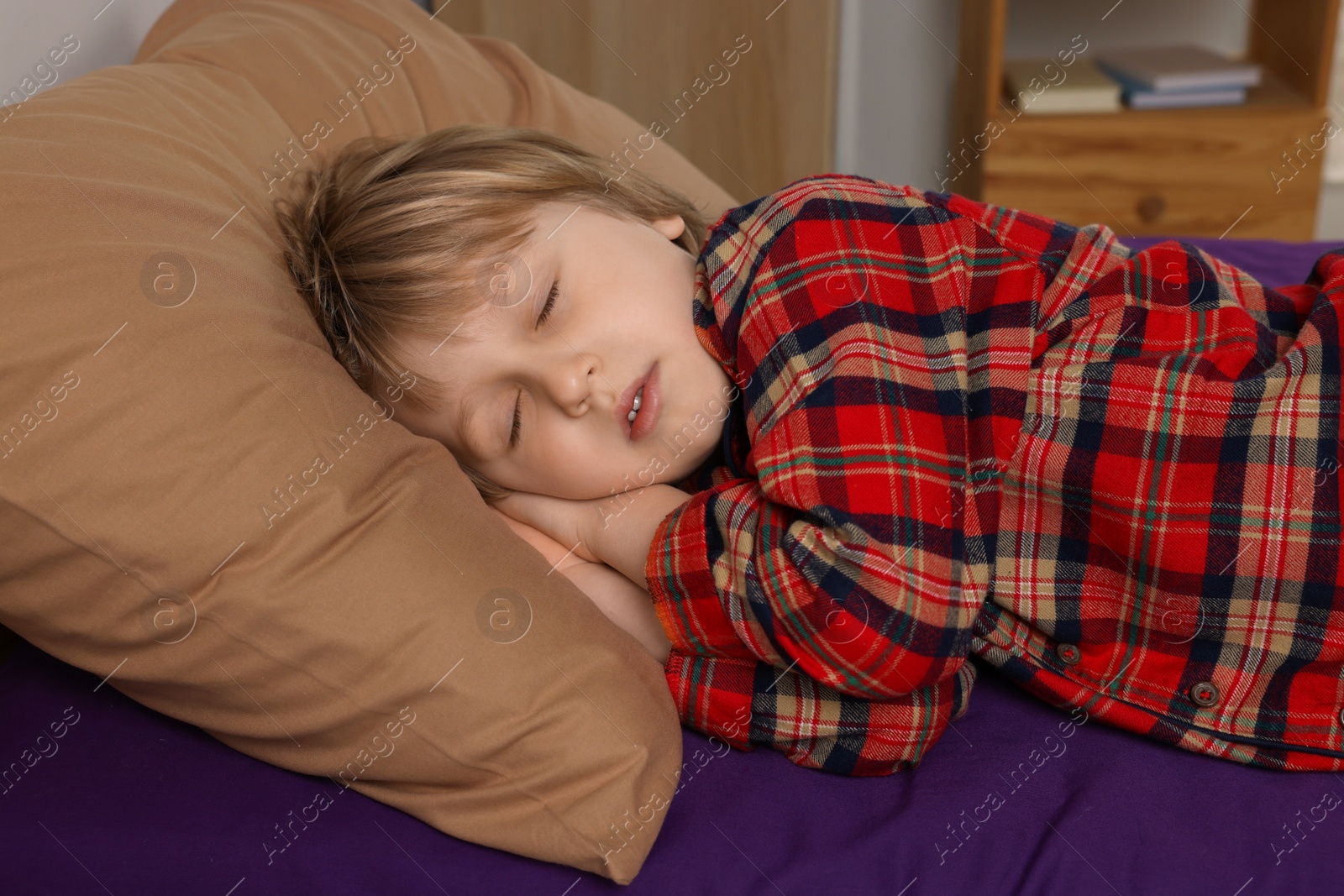 Photo of Little boy snoring while sleeping in bed at home