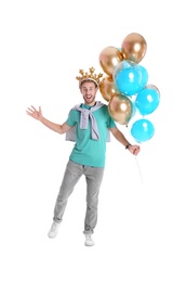 Photo of Young man with crown and air balloons on white background