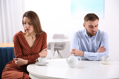 Photo of Couple with relationship problems at table in cafe