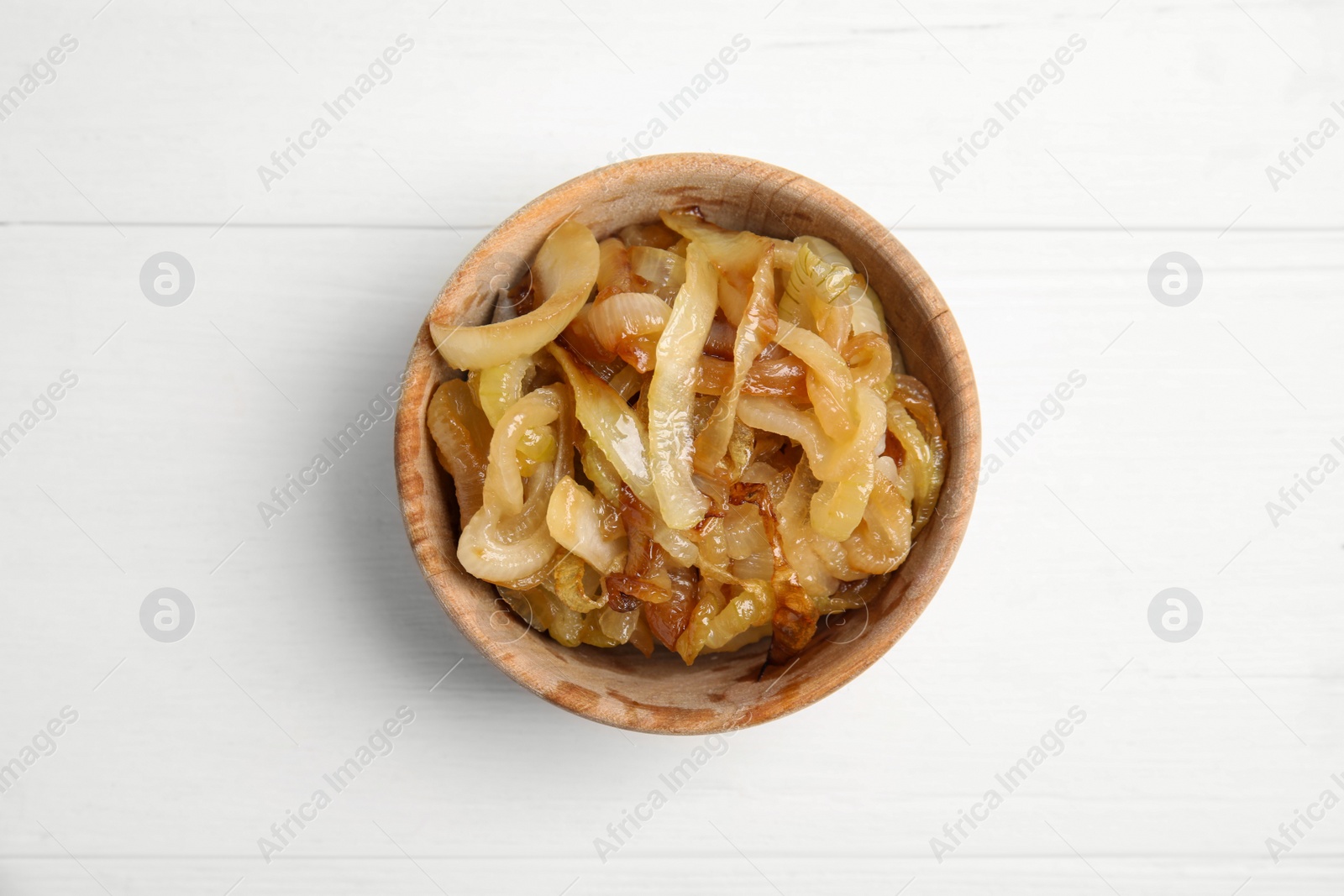 Photo of Tasty fried onion on white wooden table, top view