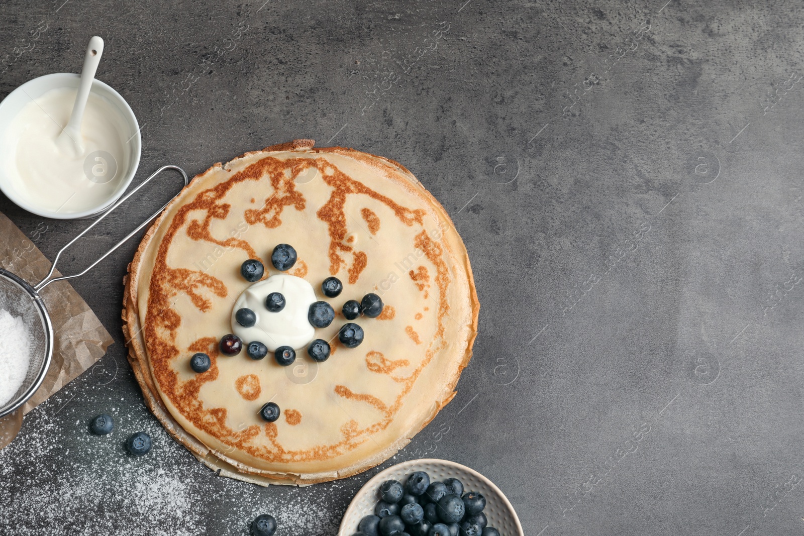 Photo of Flat lay composition with thin pancakes and berries on table