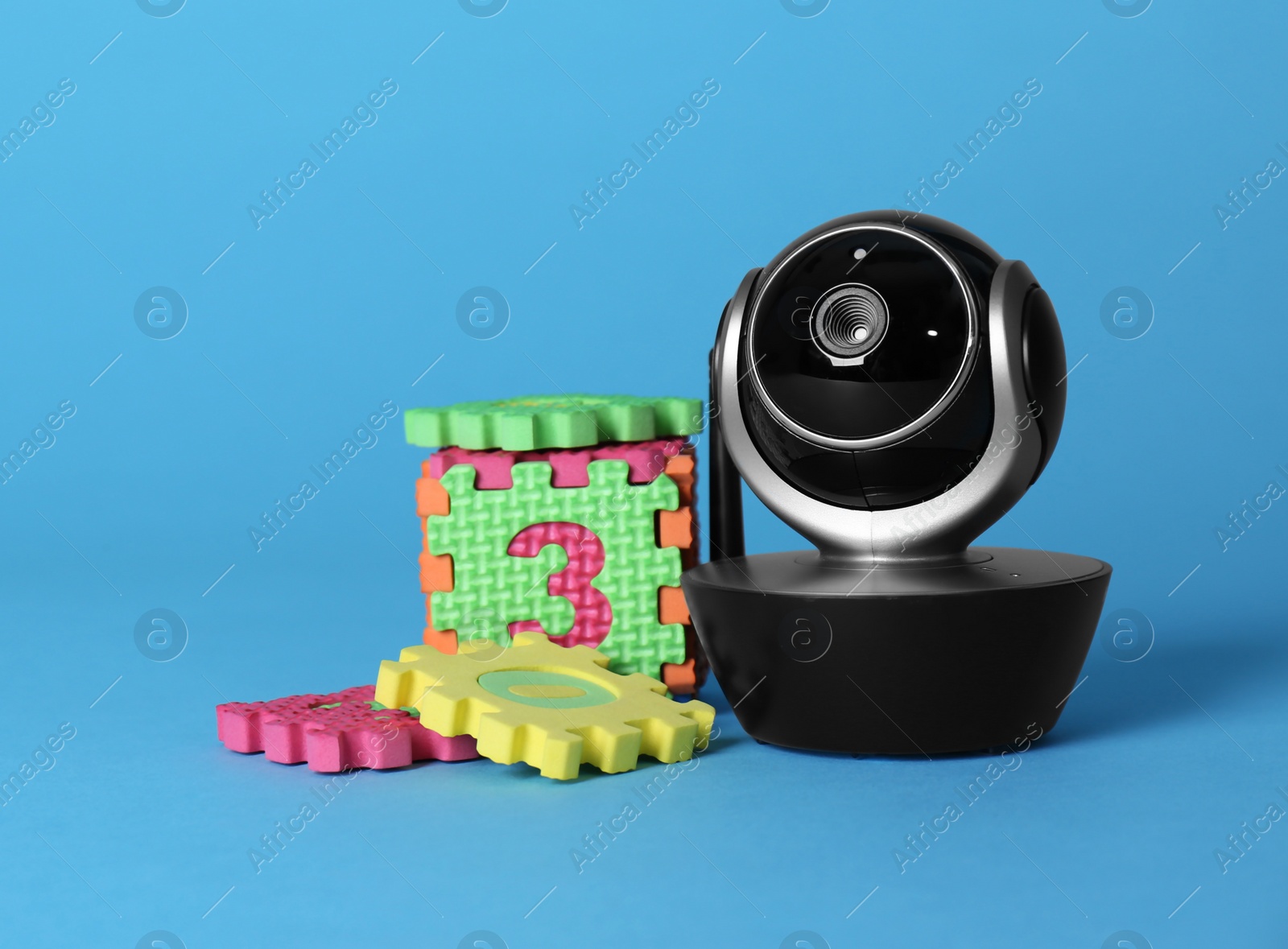 Photo of Modern CCTV security camera and child puzzle on color background