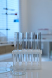 Laboratory analysis. test tubes and petri dishes on white table indoors