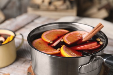 Delicious mulled wine on table, closeup view