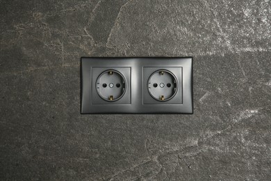 Power sockets on dark grey wall. Electrical supply