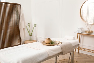 Photo of Stylish room interior with massage table in spa salon