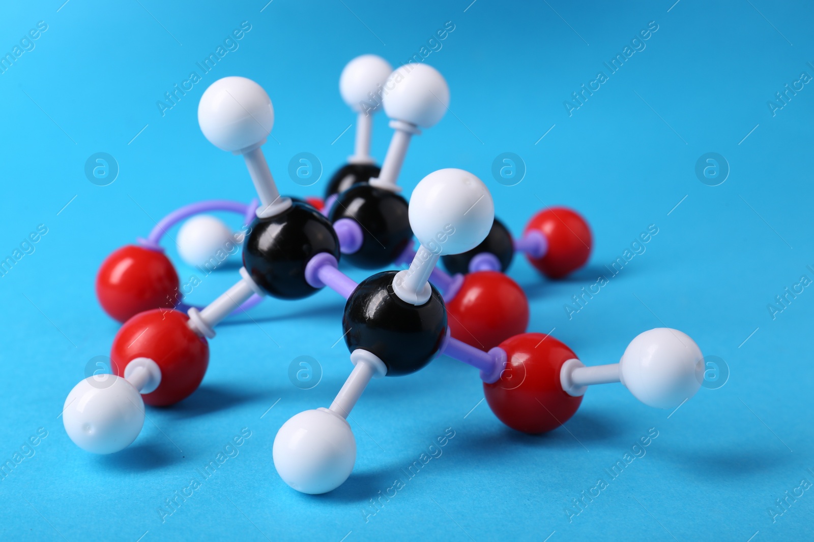 Photo of Molecule of vitamin C on light blue background. Chemical model