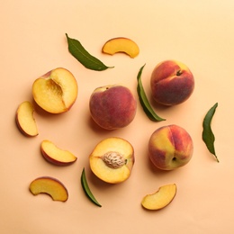 Photo of Flat lay composition with fresh peaches on beige background