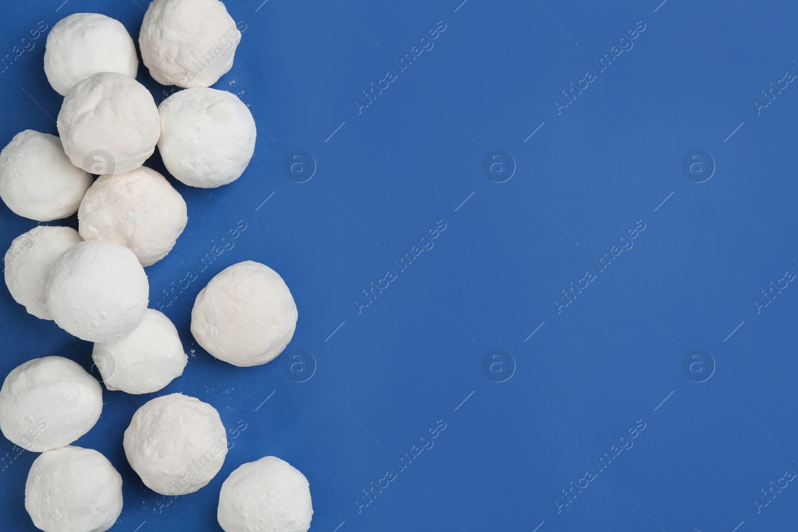 Photo of Snowballs on blue background, flat lay. Space for text