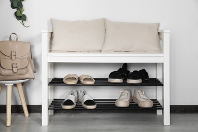 Hallway interior with shoe storage bench and backpack