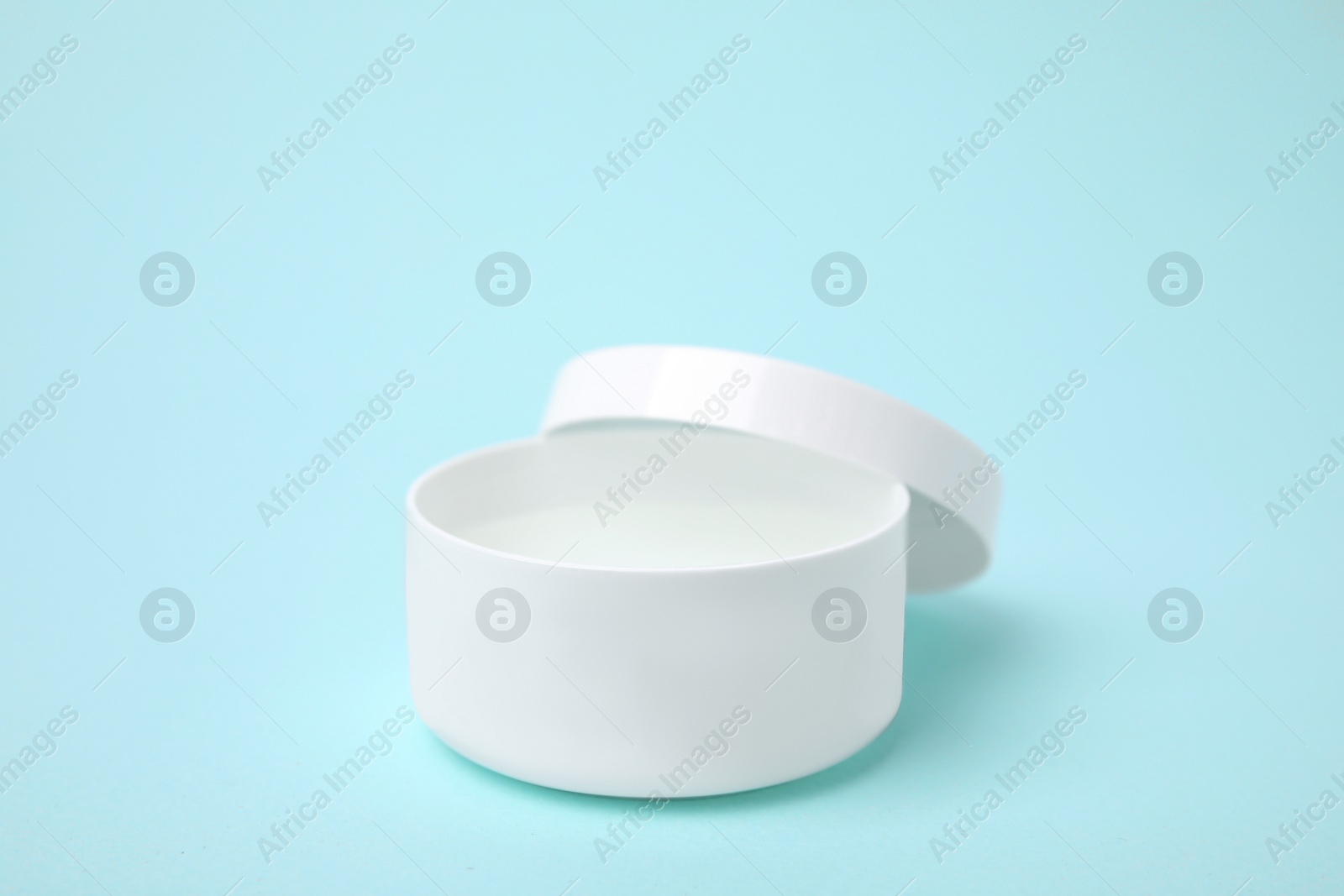 Photo of Jar of petroleum jelly on light blue background