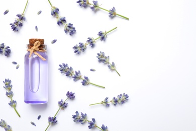 Photo of Composition with lavender flowers and natural essential oil on white background, top view