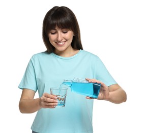 Young woman using mouthwash on white background