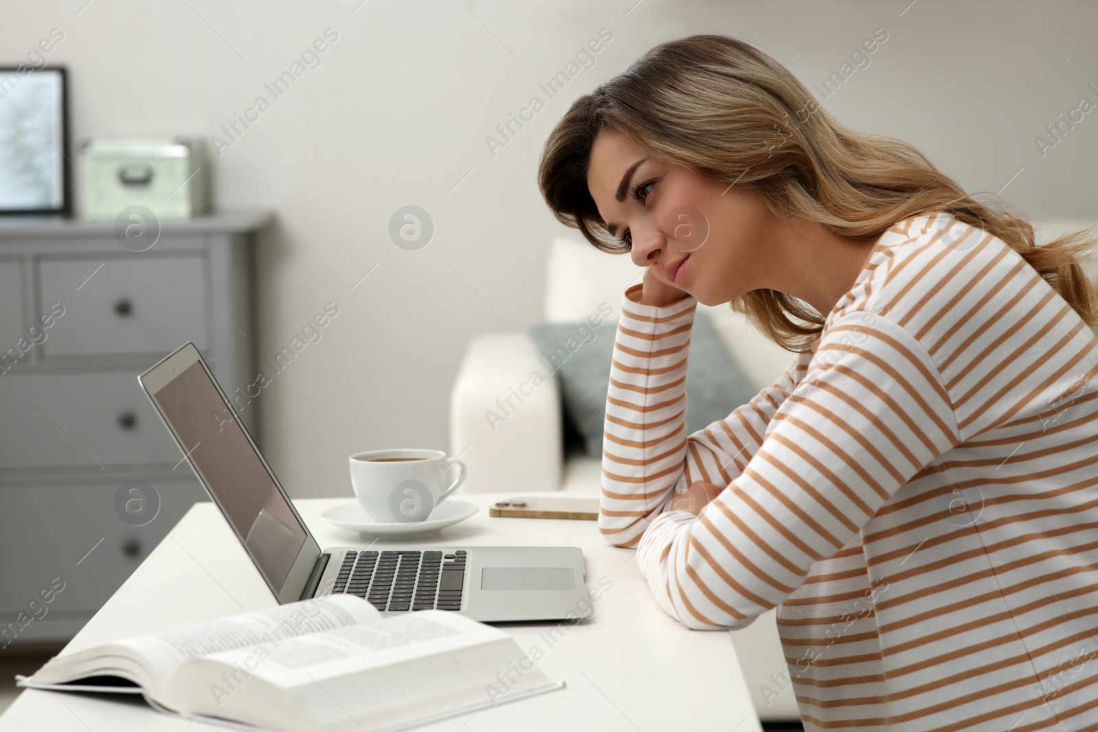 Photo of Online test. Woman studying with laptop at home