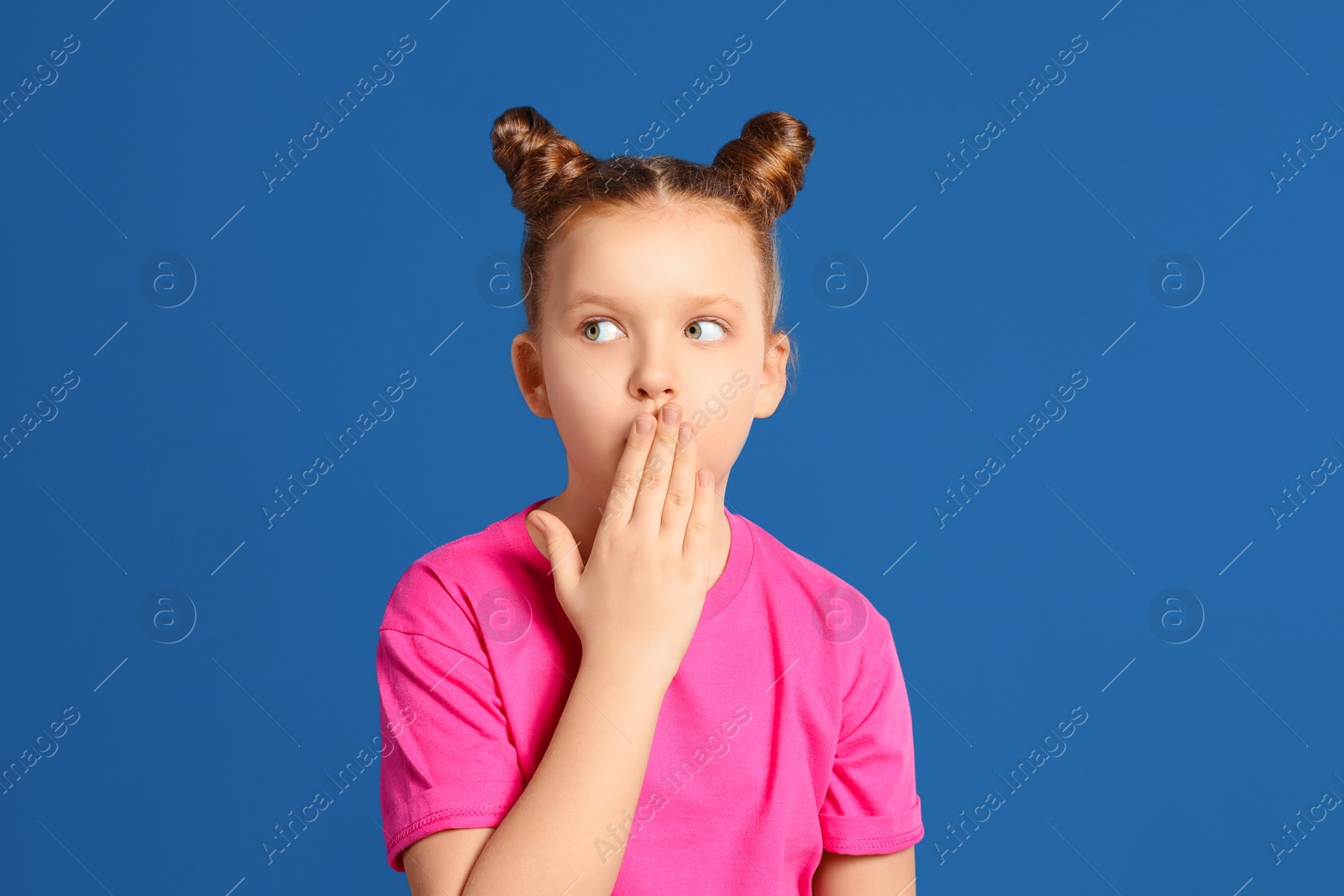 Photo of Portrait of little girl on blue background