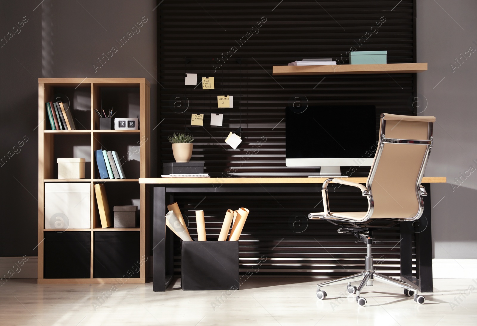 Photo of Comfortable workplace with computer and office chair. Stylish room interior