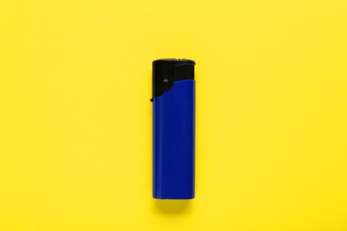 Photo of Stylish small pocket lighter on yellow background, top view