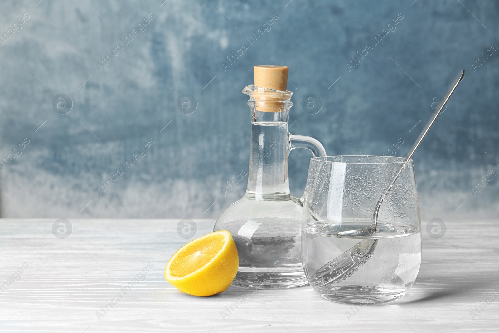 Photo of Composition with vinegar and lemon on table. Space for text