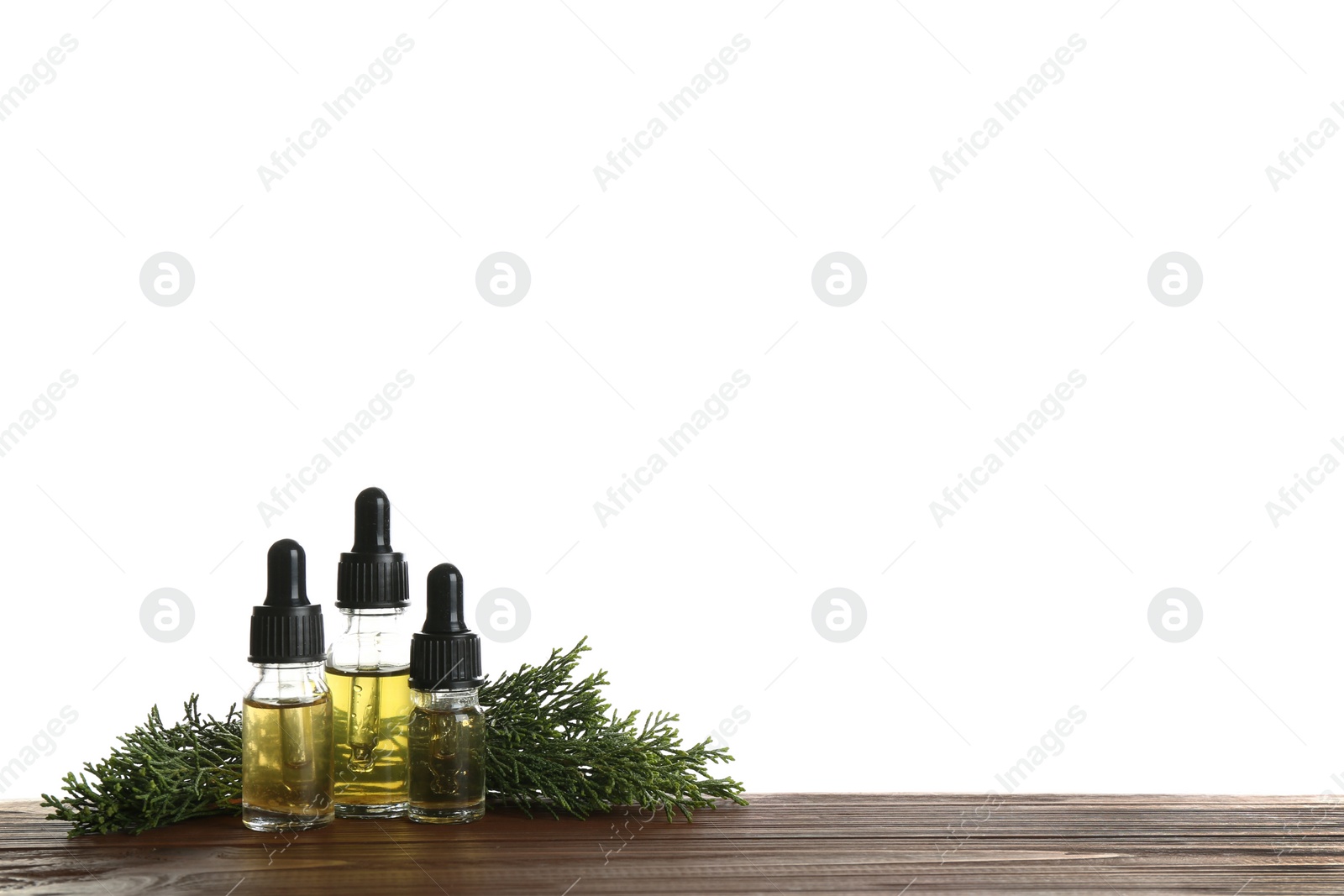 Photo of Composition with bottles of conifer essential oil on table against white background. Space for text