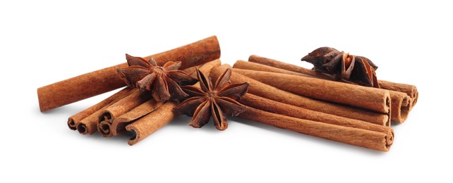 Photo of Aromatic cinnamon sticks and anise stars isolated on white