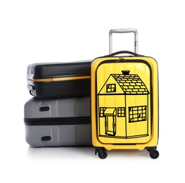 Image of Different suitcases and one with drawing of house on white background. Moving concept