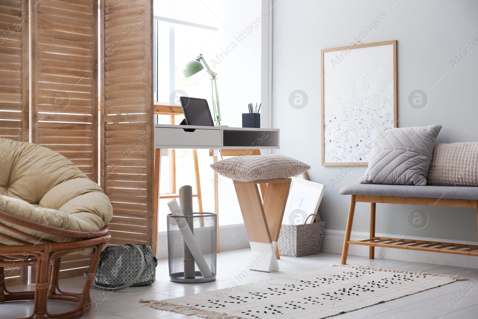 Photo of Stylish room interior with comfortable workplace near window