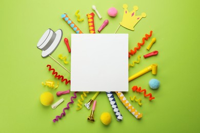 Photo of Flat lay composition with carnival items and blank card on green background. Space for text