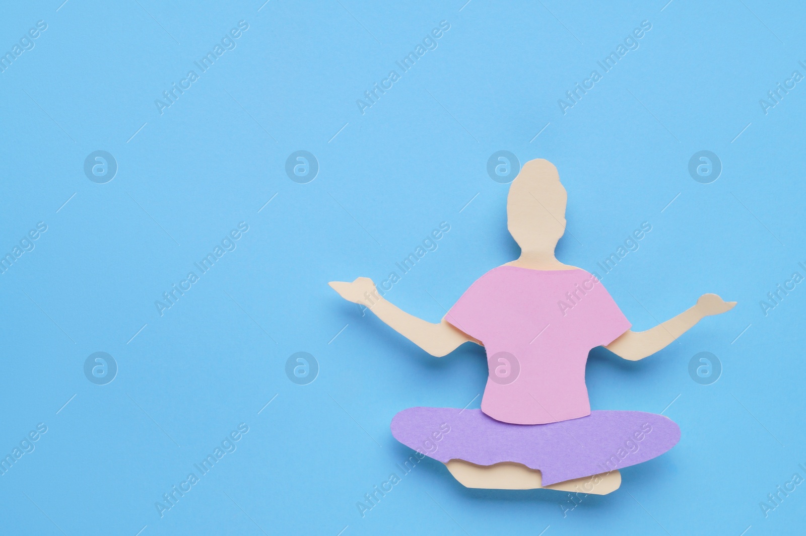 Photo of Woman`s health. Paper female figure on light blue background, top view with space for text