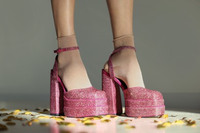 Stylish party. Woman wearing pink high heeled shoes with platform and square toes indoors, closeup