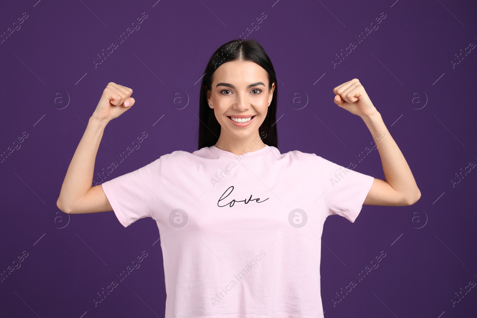 Photo of Strong woman as symbol of girl power on purple background. 8 March concept
