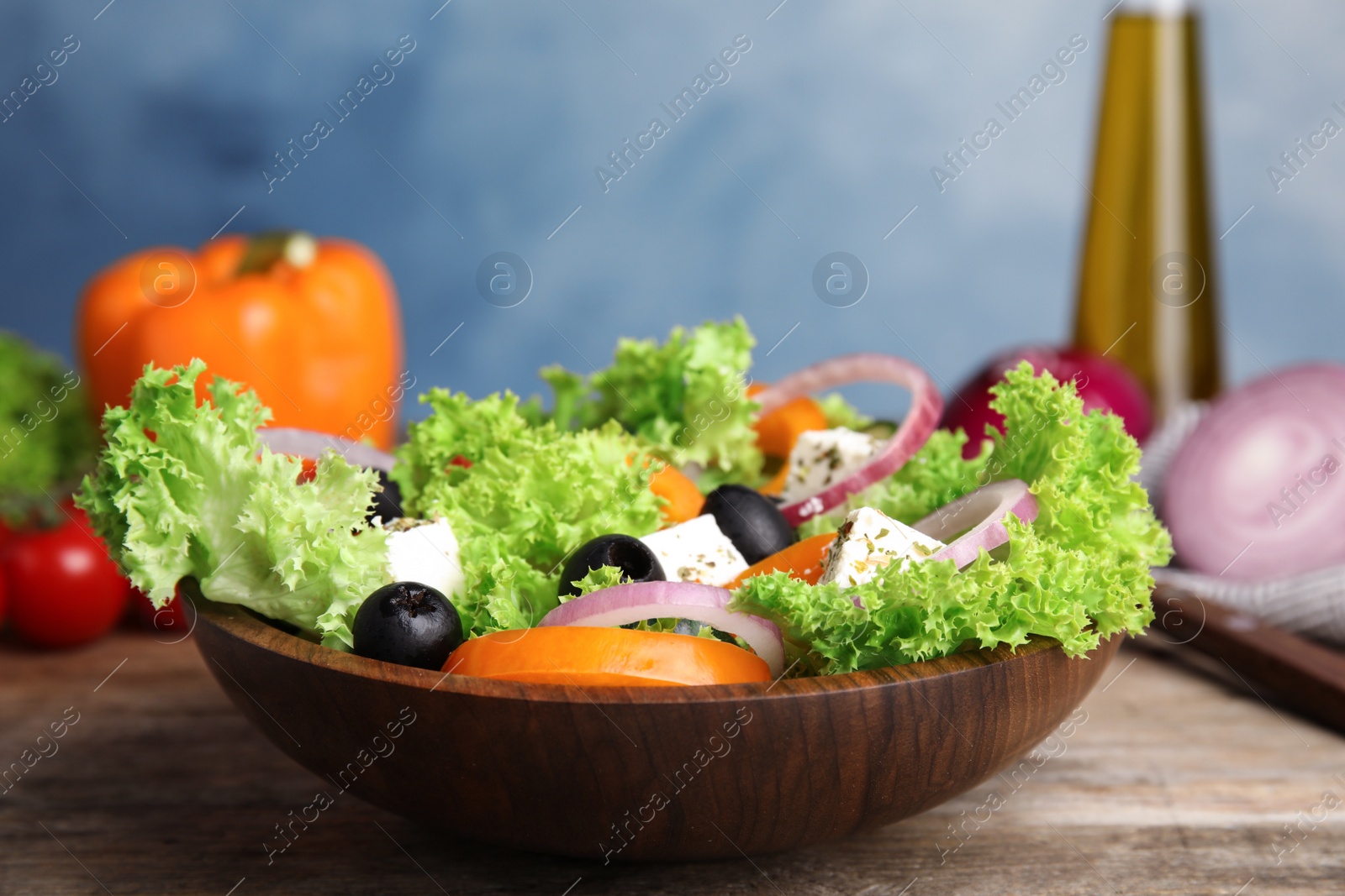 Photo of Tasty fresh Greek salad on wooden table