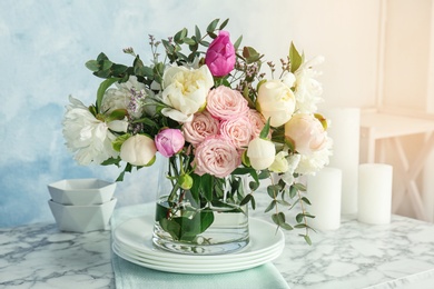 Vase with bouquet of beautiful flowers on table