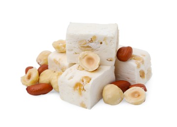 Photo of Pieces of delicious nougat and nuts on white background