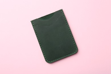 Empty leather card holder on pink background, top view
