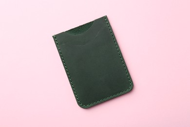 Photo of Empty leather card holder on pink background, top view