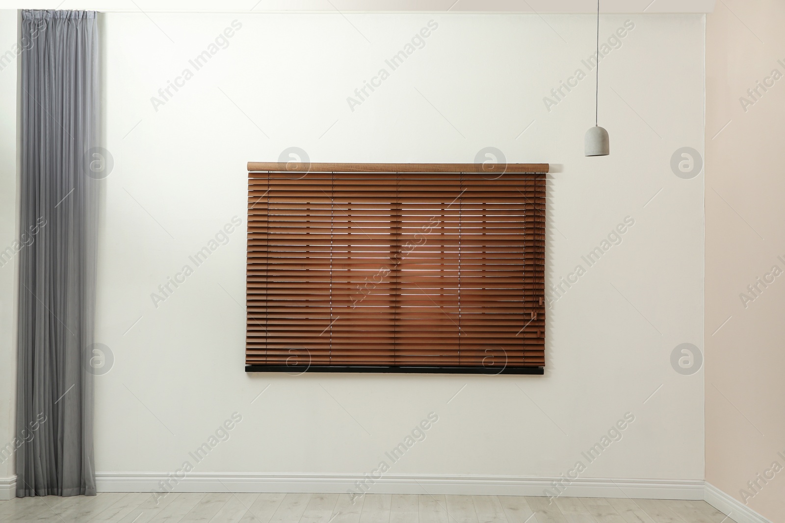 Photo of Window with closed blinds in empty room
