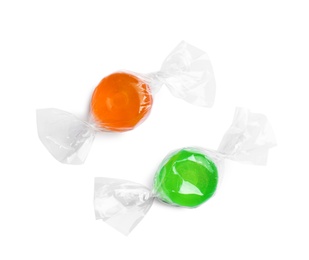 Different delicious colorful candies on white background, top view