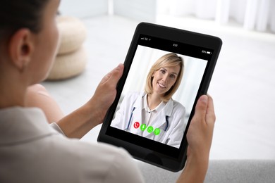 Image of Online medical consultation. Woman having video chat with doctor via tablet at home, closeup