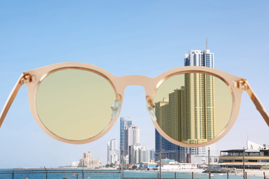 Image of Landscape with modern skyscrapers on sunny day, view through sunglasses