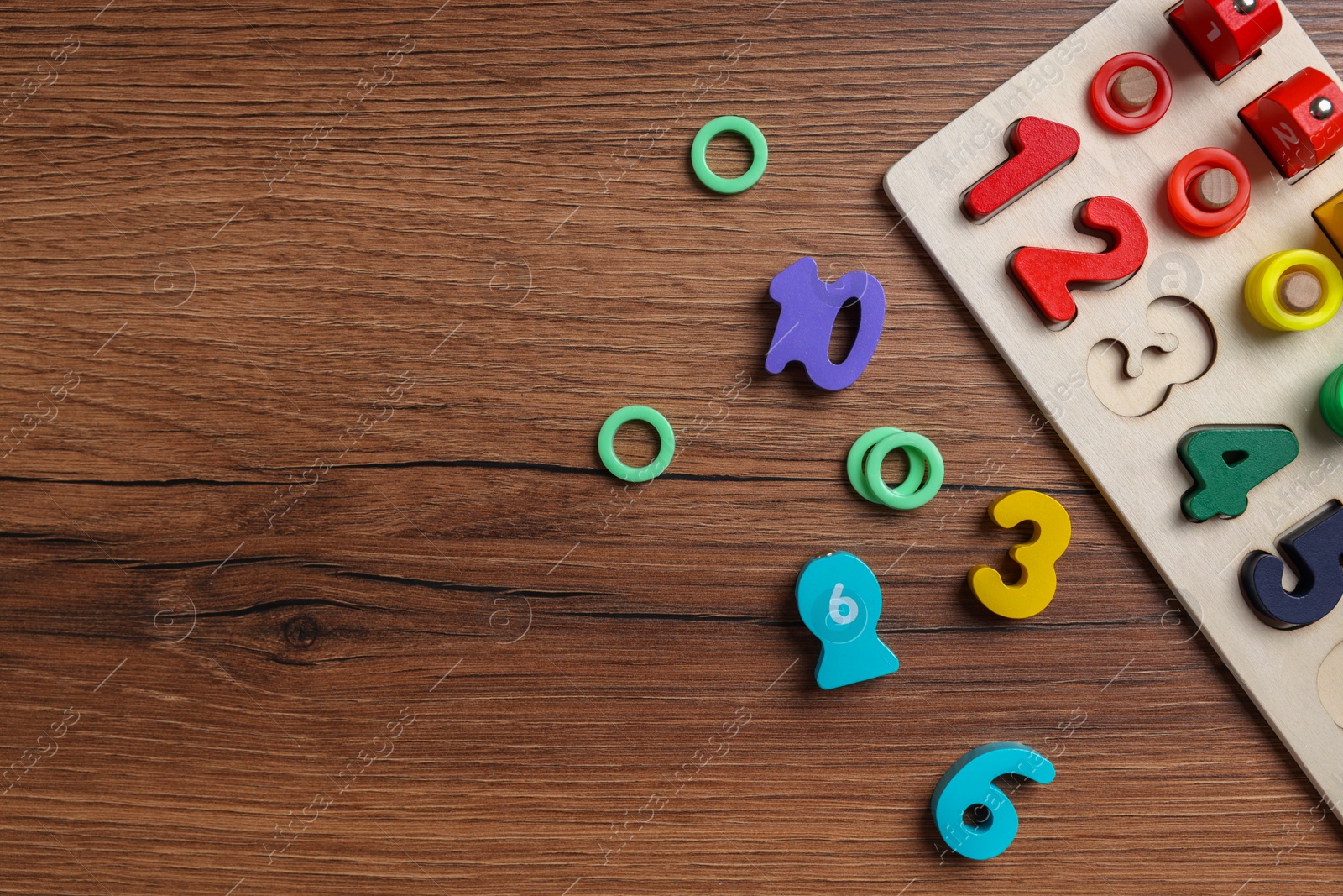 Photo of Math game Fishing for Numbers on wooden table, flat lay. Space for text